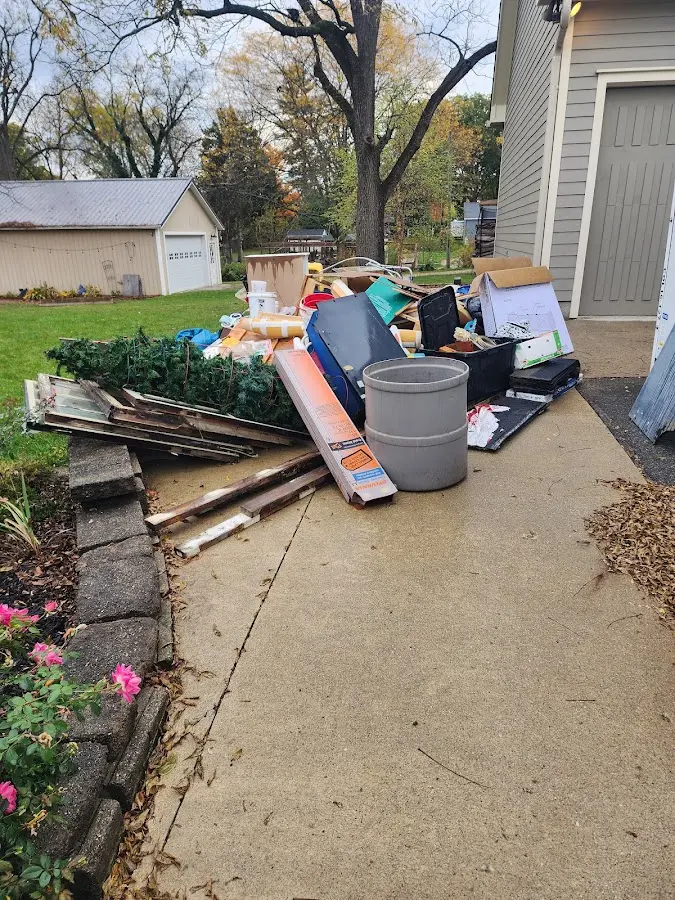 Dumpster being loaded with debris for 12 Yard Dumpster Rental in La Verkin